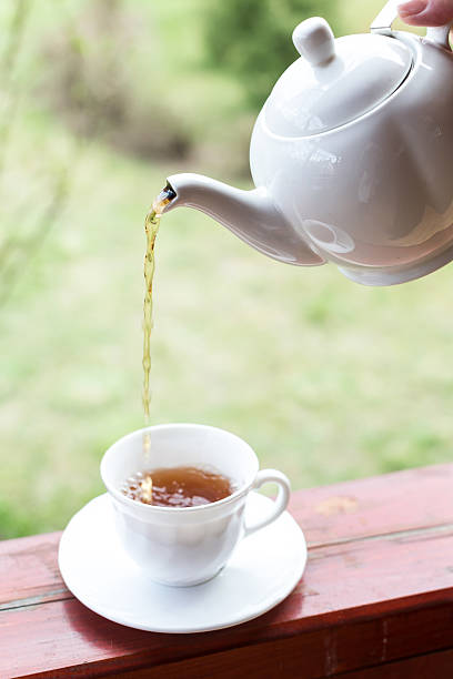 istock Cup of black tea and kettle on veranda 529404882