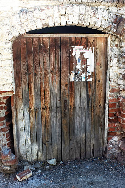 istock Wooden old door with stone arch 529405497