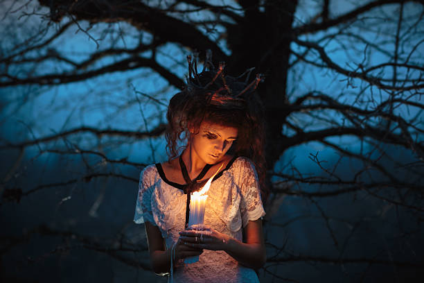 istock Girl in the image of a bride with lighted candles 529406237
