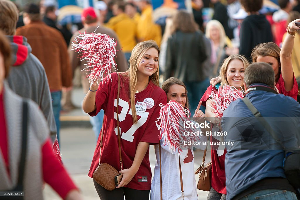 Female Alabama Fans Pose For Photo Outside Georgia Dome Atlanta, GA, USA - December 6, 2014:  Female University of Alabama fans dressed in crimson pose for a photo as they walk toward the Georgia Dome to watch the SEC Championship game against Missouri. Fan - Enthusiast Stock Photo