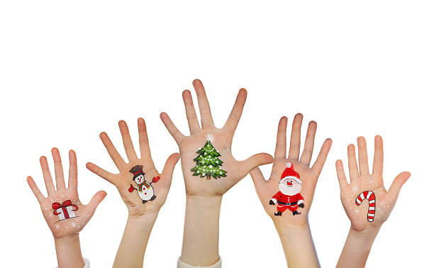 istock Kid's hands with painted Christmas symbols 529411290