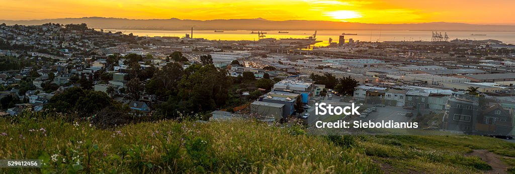 San Francisco, the Bay and industrial areas on sunrise panoramic. San Francisco, the Bay and industrial areas on sunrise panoramic image in spring. The photo shows part of San Francisco around Hunters Point with the East Bay Foothills visible in the background. Backgrounds Stock Photo