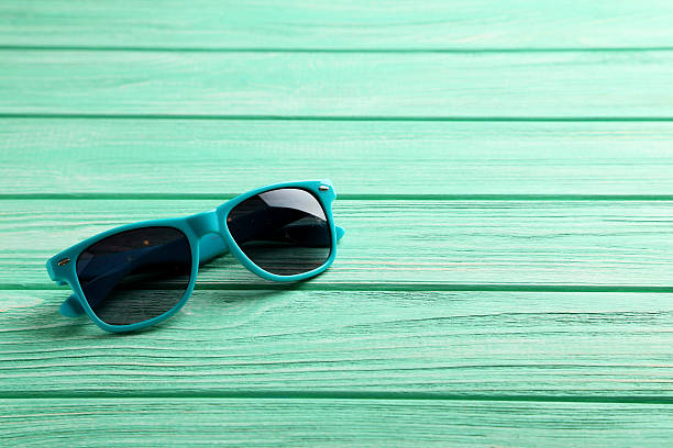 istock Sunglasses on a mint wooden table 529414812