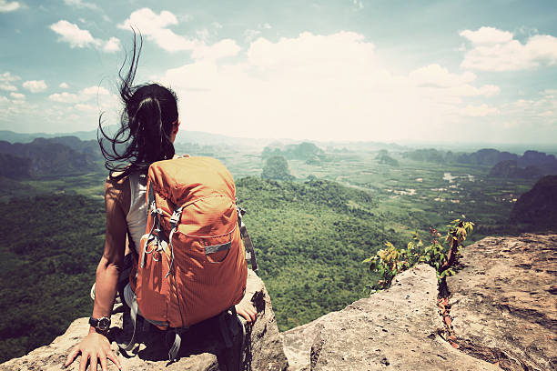 istock successful woman hiker enjoy the view on mountain top 529415480