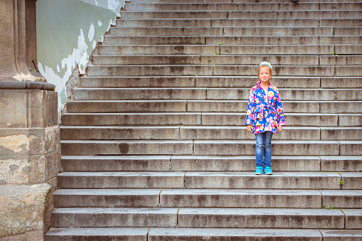 Girl on the stairs high in the District Mala Strana Prague's old town, Prague, Czech Republic