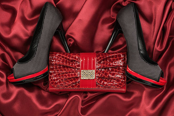 istock Black shoes and purse lying on the red satin 529416744