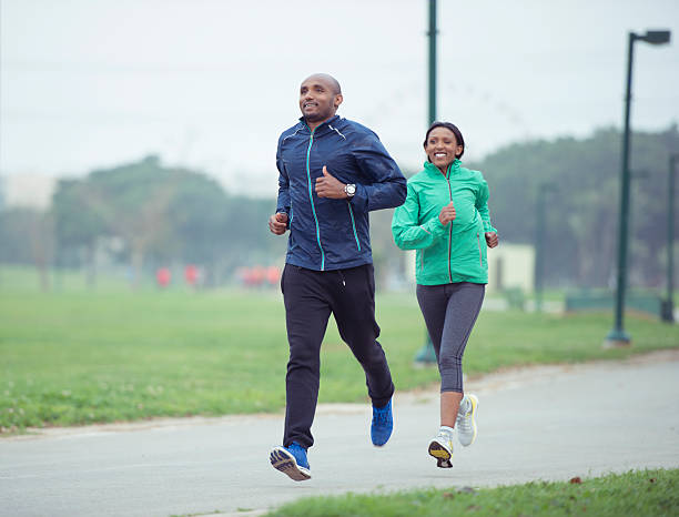 istock Couple jogging in park city. 529417638