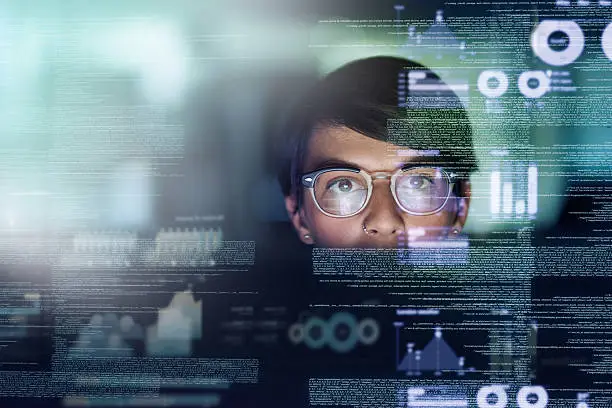 Cropped shot of a young computer programmer looking through data