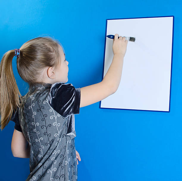 istock the girl draws on a white plastic board 529419493