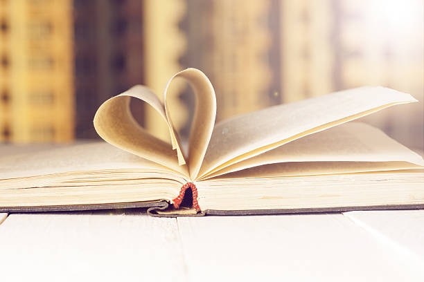 istock Open book on wood planks over abstract light background. 529419650