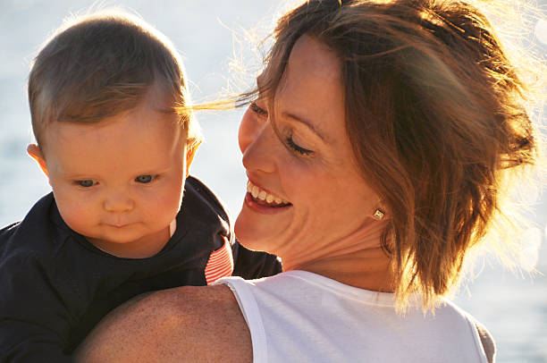 istock Mother holding her baby 529420505