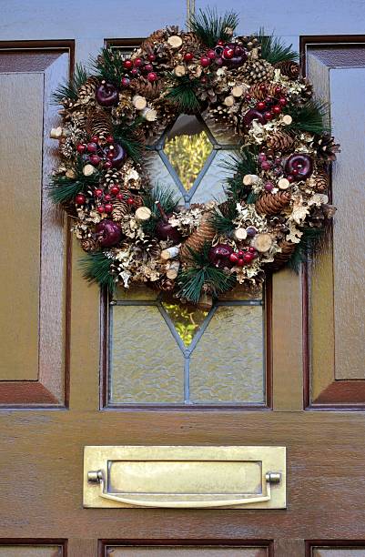 istock christmas wreath on door close-up 529421071