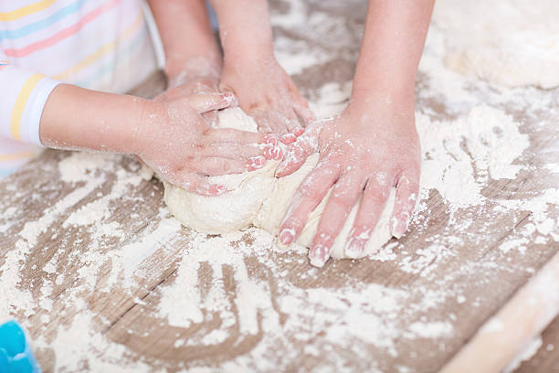 istock Family hands together working on dough 529421688