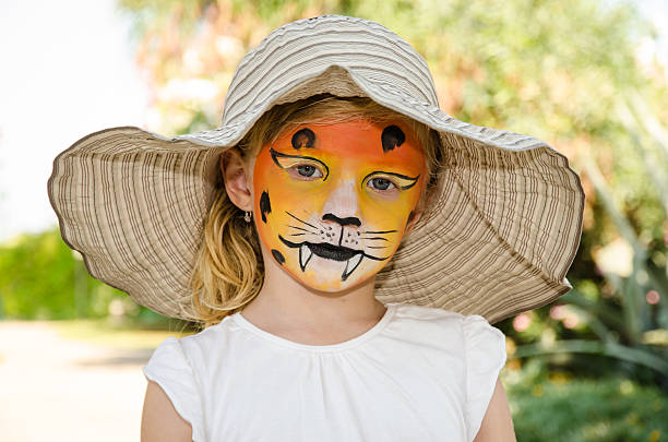 girl with tiger face painting beautiful blond girl with tiger face painting cat face paint stock pictures, royalty-free photos & images