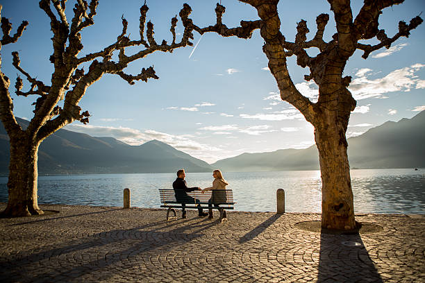 istock People flirting on bench at sunset near lake 529422463