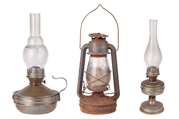 istock Three antique kerosene lamps isolated on white background 529423285