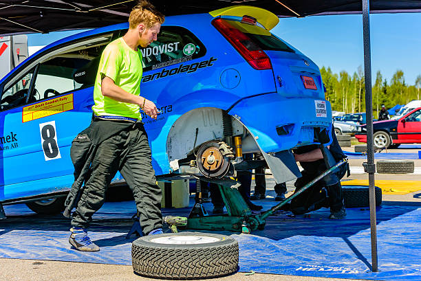 Emmaboda, Sweden - May 7, 2016: 41st South Swedish Rally in service depot. Back wheel is of the blue Ford Fiesta St at team Lundqvist (8). Tire is on the ground beside.