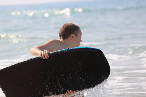 istock Little boy surfer enjoying sea 529423681