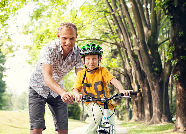 istock Father learn his son to ride bicykle 529423946