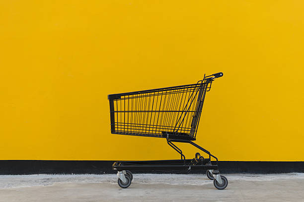 istock Minimalism style, Shopping cart and yellow wall. 529425536