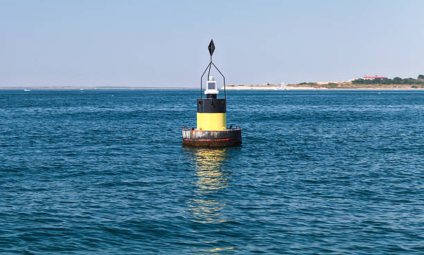 istock Black modern navigation buoy with yellow stripe 529425646