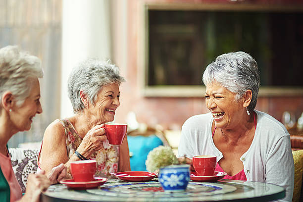 Lifelong friends catching up over coffee Shot of a group of elderly friends having coffee together women only restaurant stock pictures, royalty-free photos & images