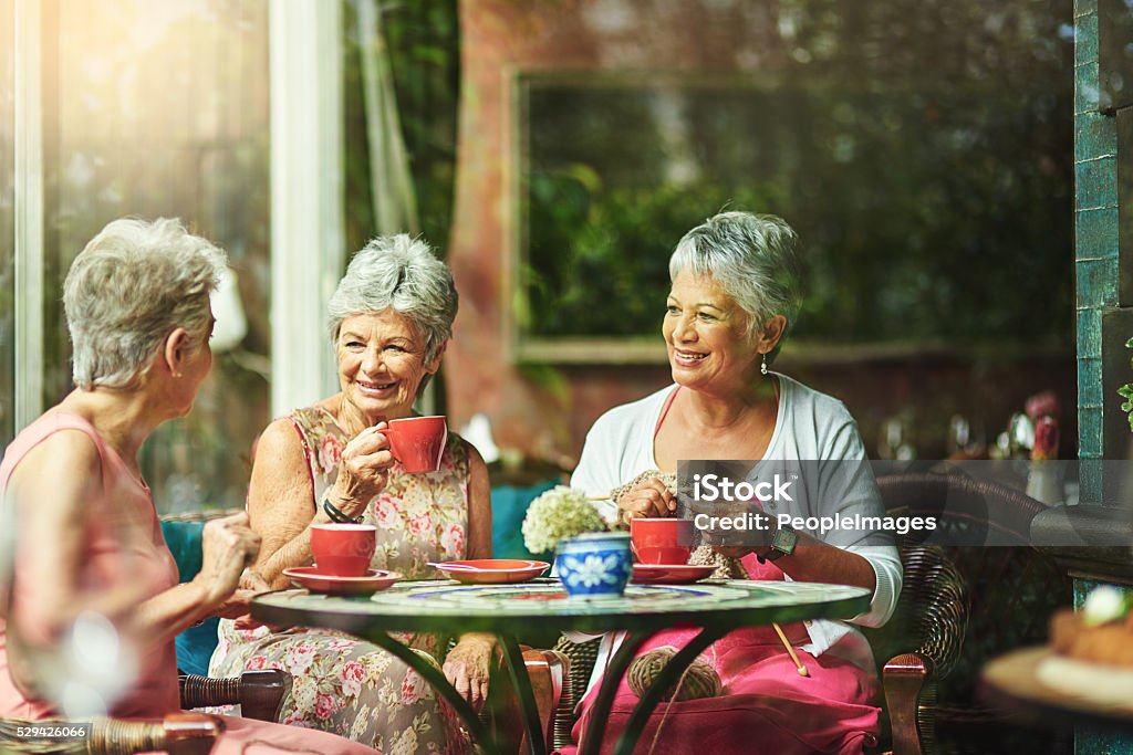 Making time to catch up with good old friends Shot of a group of elderly friends having coffee together Senior Adult Stock Photo