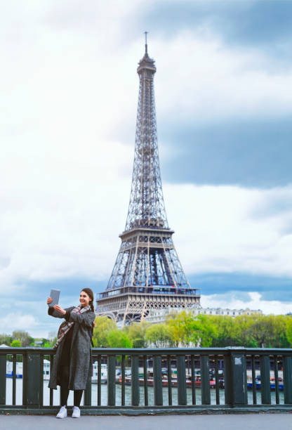 istock French woman taking selfie with digital tablet  (panoramic) 529426414