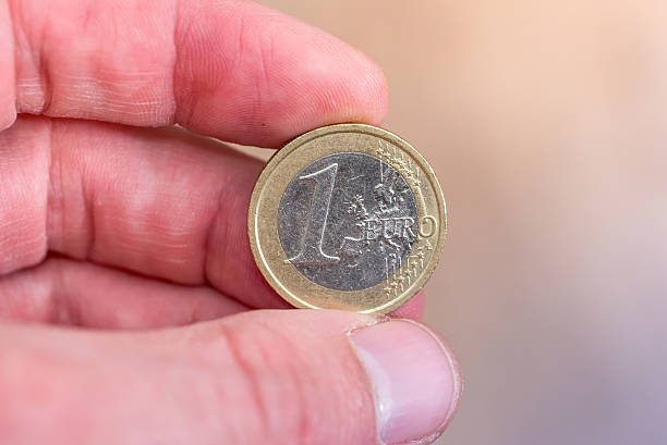 istock Hand with coin on wooden background 529426502