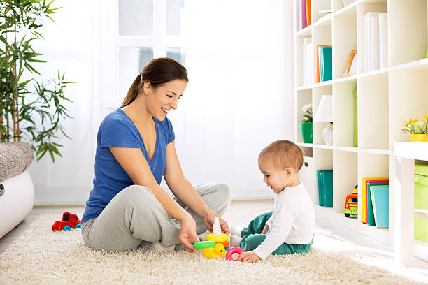 Happy smiling family playing with toys Happy smiling family playing with toys on floor duck family stock pictures, royalty-free photos & images