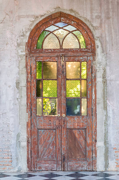 istock Ancient wooden door in stone wall 529428942