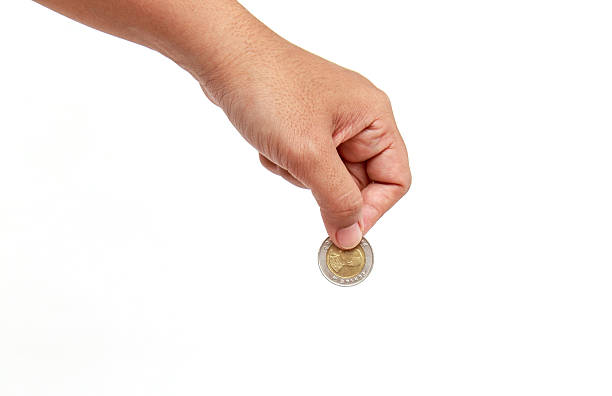 istock Woman hand holding coin isolates on white background 529433703