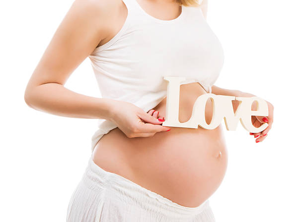 istock Pregnant woman on white 529434993