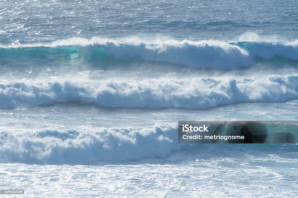 Three waves breaking against the coast Set of three waves breaking in rough seas Breaking Stock Photo