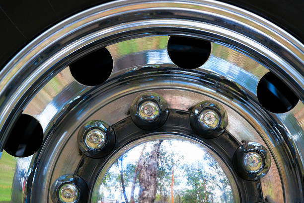 Closeup truck shiny hubcap wheel with reflection, full frame horizontal composition