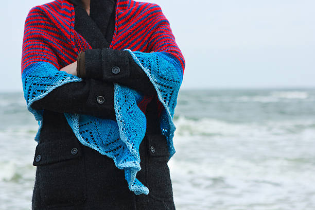 Girl in a shawl on a sea bank