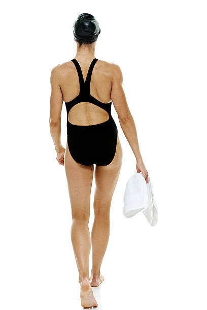 istock Female swimmer holding towel & walking 529438357