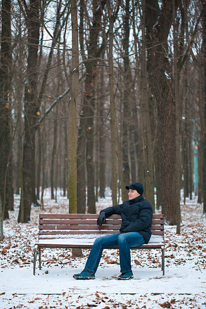 Lonely man in snowy forest stock photo