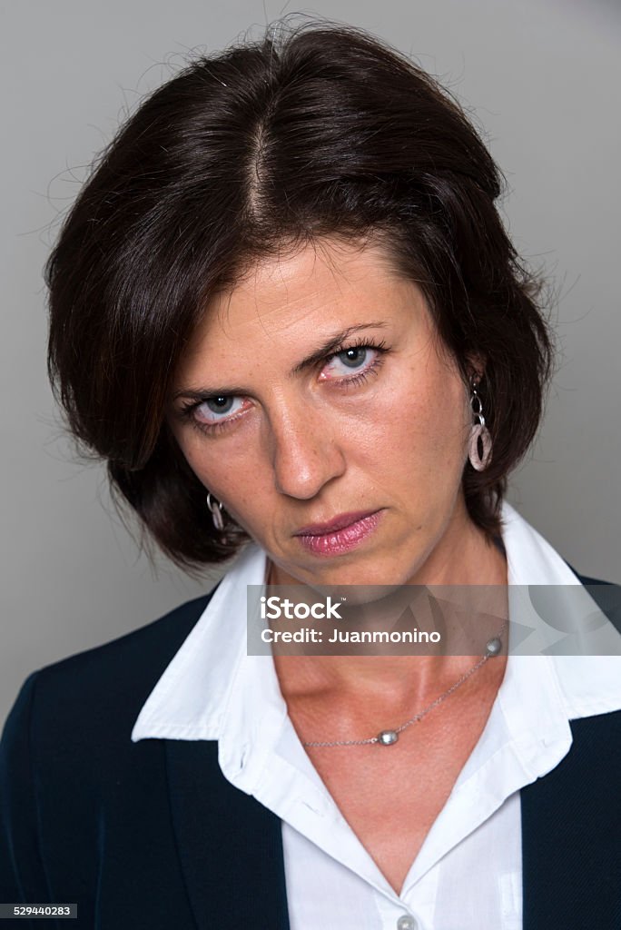 Forty something caucasian woman Headshot of a Forty something caucasian woman on gray background 40-44 Years Stock Photo