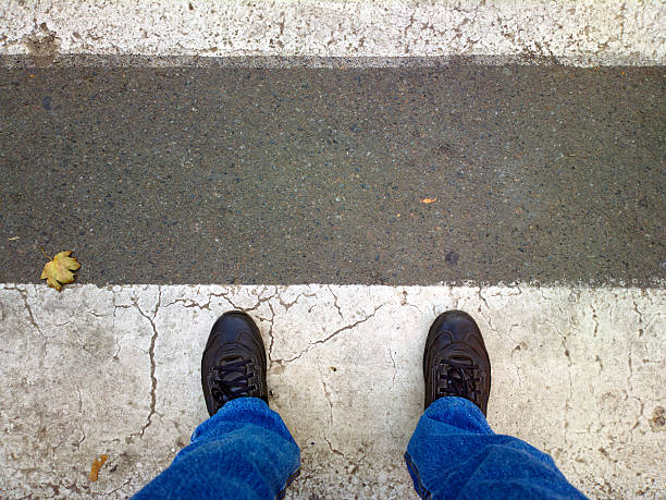 istock Feet on the pedestrian crossing. 529456323