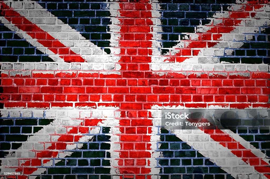 Brick Wall Britain An image of the union jag flag painted on a brick wall in an urban location Abstract Stock Photo