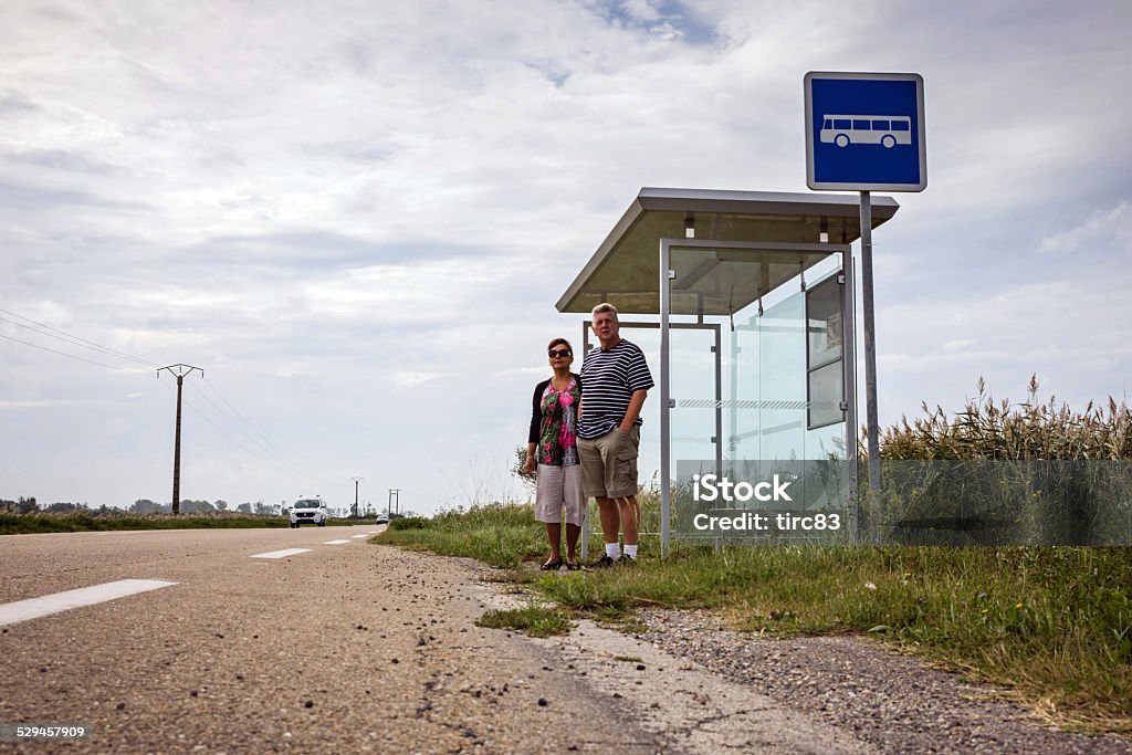 Mature couple waiting at French bus stop Waiting Stock Photo