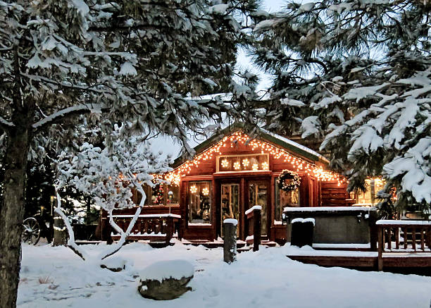 Cabin with Christmas Lights Christmas lights on wooden Colorado mountain country cabin in snow and  pine trees log cabin photos stock pictures, royalty-free photos & images