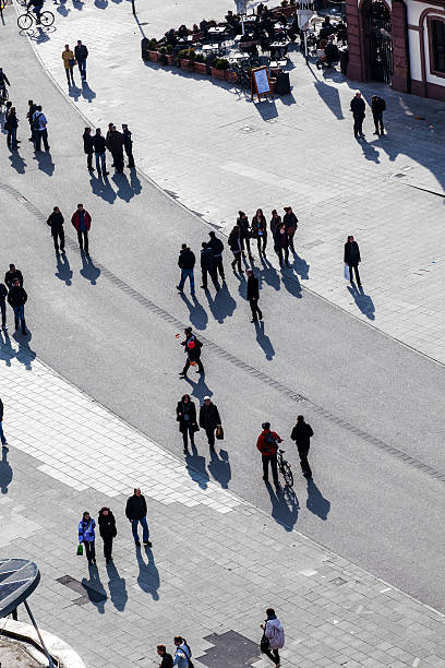istock people walking at the street with long shadows 529459503