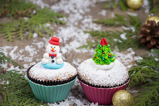 istock Festive cupcake with  Christmas tree and snowman 529462095
