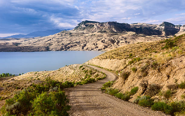 Buffalo Bill State Park, Cody, Wyoming, USA. Cody, Wyoming, USA - View across the rugged undulating landscape of Buffalo Bill State park showing the reservoir, rocky mountains near Cody, Wyoming, USA. This image was taken early in the morning during late summer.  wyoming stock pictures, royalty-free photos & images