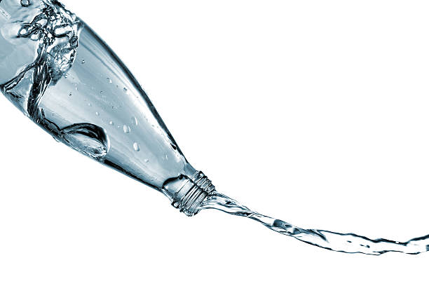 istock Glass bottle pouring water isolated on white 529462483