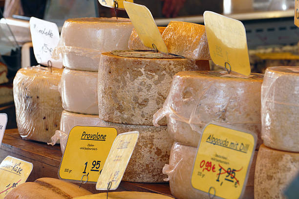 istock cheese wheels, different sorts, at the farmers market 529480341