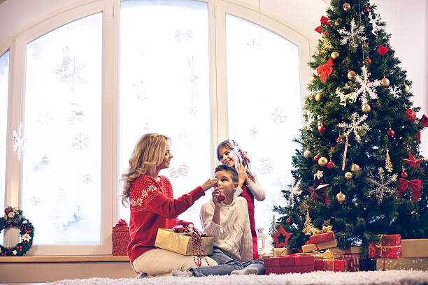 istock Family decorating Christmas tree 529481363