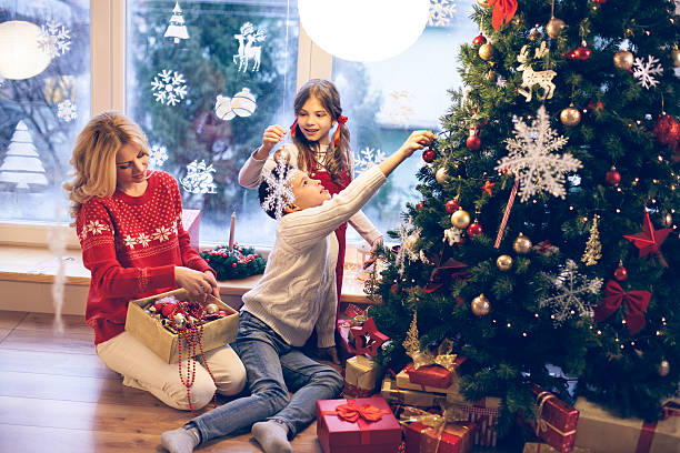 Family decorating Christmas tree